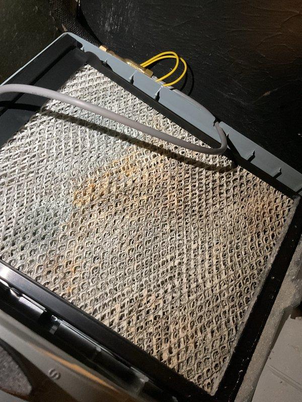 Completed scheduled furnace tune-up and maintenance on a two-and-a-half-year-old heating system. Inspected and serviced all major components, including air filtration system which showed moderate dust accumulation with visible discoloration in the lower quadrant of the filter media. Checked Aprilaire Model 60 Automatic Humidifier Control unit, confirmed operational status with humidifier actively running at 35% humidity setpoint and green indicator light illuminated. All system components tested and verified to be functioning within normal parameters.