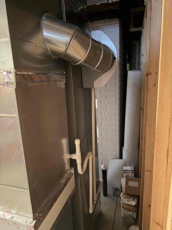 Completed full HVAC system installation including new 90% efficiency furnace and air conditioning condenser unit. Installed new furnace in basement mechanical room with reused existing flue system, connected metallic supply ductwork with proper transitions and elbows, and established PVC condensate drainage lines. Mounted new outdoor AC condenser with fused disconnect box, verified all electrical connections, and tested system operation to ensure proper heating and cooling functionality.