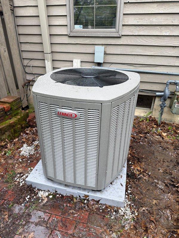 Completed installation of new Lennox 90% AFUE gas furnace and air conditioning system at residential property. Installed outdoor condensing unit on concrete pad against exterior wall with proper clearances and mounted electrical disconnect box with 35-amp Littelfuse FLNR fuses for equipment protection. Ran refrigerant lines, established electrical connections, and verified all components operational per manufacturer specifications.