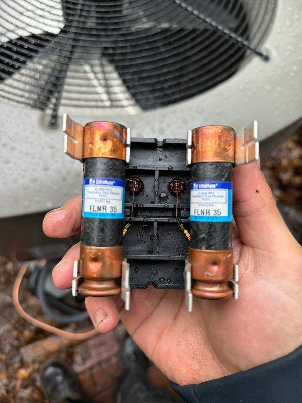 Completed installation of new Lennox 90% AFUE gas furnace and air conditioning system at residential property. Installed outdoor condensing unit on concrete pad against exterior wall with proper clearances and mounted electrical disconnect box with 35-amp Littelfuse FLNR fuses for equipment protection. Ran refrigerant lines, established electrical connections, and verified all components operational per manufacturer specifications.