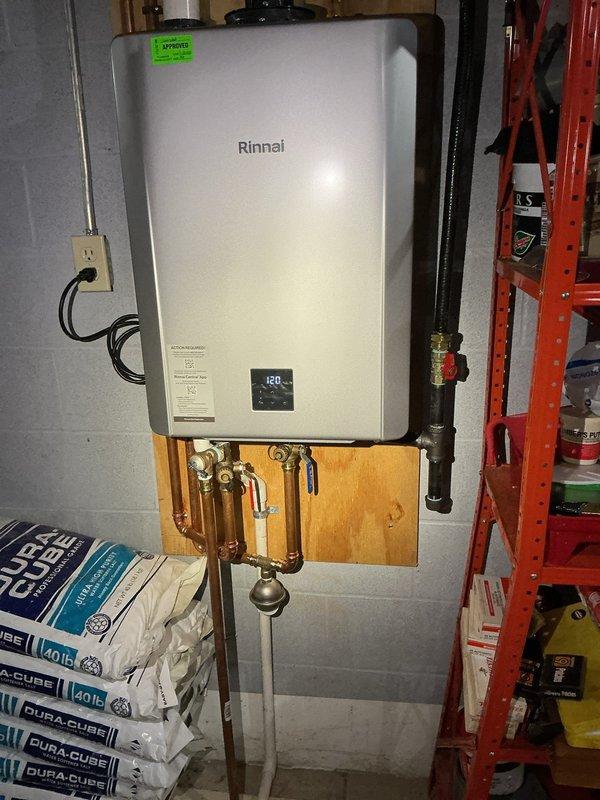 Performed preventative maintenance descaling service on Rinnai RK100T1 tankless water heater (Serial #J58 RA-174499). Flushed unit with descaling solution to remove mineral buildup and maintain optimal heat exchanger efficiency. Verified all inlet/outlet connections, confirmed digital display functioning properly at 160°F setpoint, and ensured unit returned to normal operation upon completion.