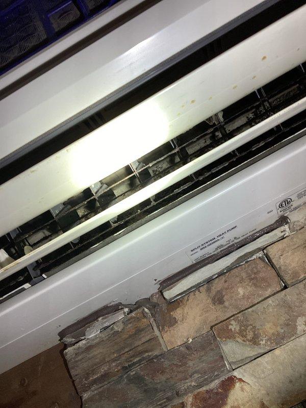 Completed BS-MVP cooling maintenance visit on 13-year-old mini split system with air handler located in attic. Upon inspection, discovered extensive frost and ice buildup on evaporator coils, indicating potential refrigerant flow restriction, low refrigerant charge, or airflow deficiency. Documented system condition with photos showing frozen coil assembly and electrical components for service records.