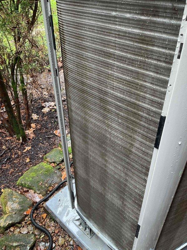 Completed yearly air conditioning maintenance on three-year-old outdoor condensing unit. Inspected heat exchanger coils and found moderate accumulation of dirt, dust, and environmental debris on aluminum fins, particularly in middle and upper sections. Performed standard tune-up procedures including system performance evaluation and component inspection to ensure proper operation for upcoming cooling season.
