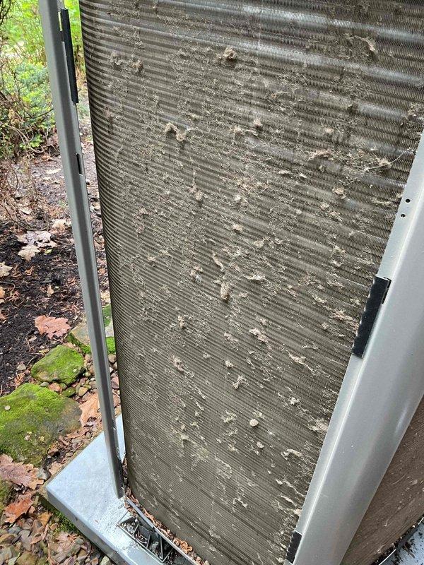 Completed yearly air conditioning maintenance on three-year-old outdoor condensing unit. Inspected heat exchanger coils and found moderate accumulation of dirt, dust, and environmental debris on aluminum fins, particularly in middle and upper sections. Performed standard tune-up procedures including system performance evaluation and component inspection to ensure proper operation for upcoming cooling season.