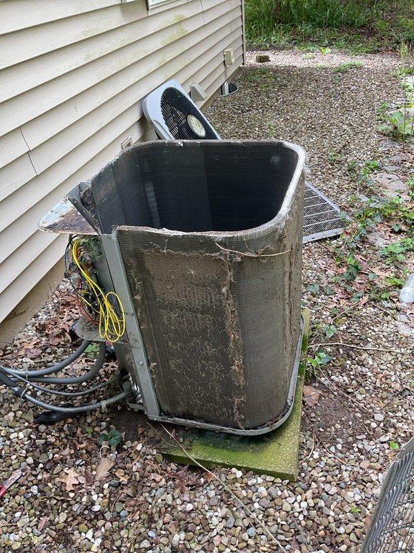 Completed scheduled MVP cooling maintenance visit on 10-year-old air conditioning system. Performed comprehensive inspection of outdoor condenser unit, which displayed significant wear and aging consistent with its service life. Noted extensive dirt accumulation on exterior casing and damaged top panel requiring attention. Inspected internal components, coils, and fan assembly. Verified electrical connections and conduit routing. Unit operational at time of service. Documented equipment condition with photographs for maintenance records.