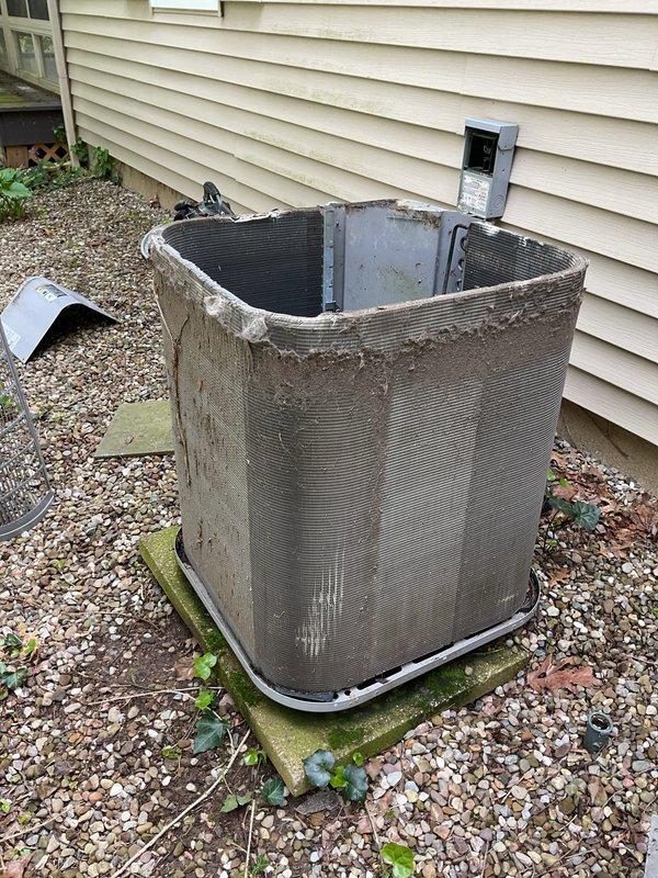 Completed scheduled MVP cooling maintenance visit on 10-year-old air conditioning system. Performed comprehensive inspection of outdoor condenser unit, which displayed significant wear and aging consistent with its service life. Noted extensive dirt accumulation on exterior casing and damaged top panel requiring attention. Inspected internal components, coils, and fan assembly. Verified electrical connections and conduit routing. Unit operational at time of service. Documented equipment condition with photographs for maintenance records.