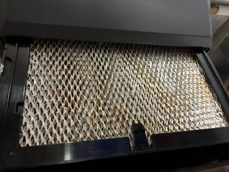 Completed air conditioning tune-up and seasonal maintenance inspection. Documented existing humidifier evaporator pad showing significant mineral buildup and scaling, indicating need for replacement to maintain proper humidity control and system efficiency. Provided complimentary carbon monoxide detector installation for enhanced safety.