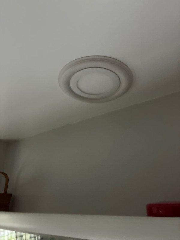 Installed two new LED wafer lights in the bathroom, positioning one over the sink and another over the shower area, with wiring tied into the existing exhaust fan circuit. Ran new electrical circuit and installed switch near the garage attic access, then added an additional light fixture approximately halfway into the attic space to improve illumination throughout the attic area. Replaced customer-supplied range hood vent and installed new exterior venting system with ductwork routed through the soffit, including the installation of exterior vent termination cap to properly exhaust cooking fumes outside the residence.