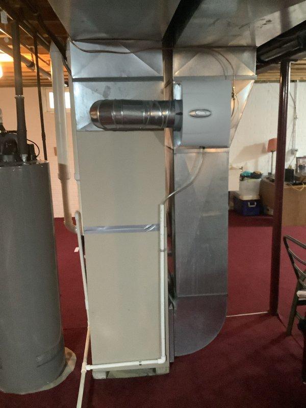 # HVAC Install - Complete System

Successfully completed installation of a comprehensive residential HVAC system in basement utility area. Installed new Lennox furnace unit as primary heating source, properly positioned with adequate service clearances between structural support beams. Configured and connected black metal ductwork to furnace, routing through exposed ceiling joists to distribute conditioned air throughout residence. Installed cylindrical water heater adjacent to furnace for efficient space utilization. Ran copper refrigerant lines and associated piping along wall to connect outdoor condensing unit for 90% efficiency air conditioning system. Secured all ductwork with appropriate supports and hangers from ceiling joists. Ensured proper electrical connections, gas lines, and condensate drainage per manufacturer specifications and local building codes. Verified all equipment clearances meet safety requirements for maintenance access. Applied manufacturer specification label