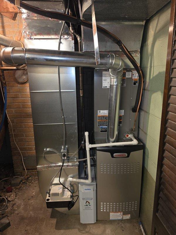# HVAC Install - Complete System

Completed installation of a new 80% efficiency furnace system with integrated humidification. Installed Lennox furnace unit with proper venting and ductwork connections, including metallic supply ducts with appropriate elbow configurations for optimal airflow distribution. Mounted and connected white whole-home humidifier unit with PVC drainage plumbing and water supply lines. Installed dual FLNR 35 amp fuse protection in Littelfuse fuse holder for electrical circuit safety. Verified all electrical connections, tested system operation, and ensured proper humidifier integration with furnace controls. System commissioned and left in full operational status.
