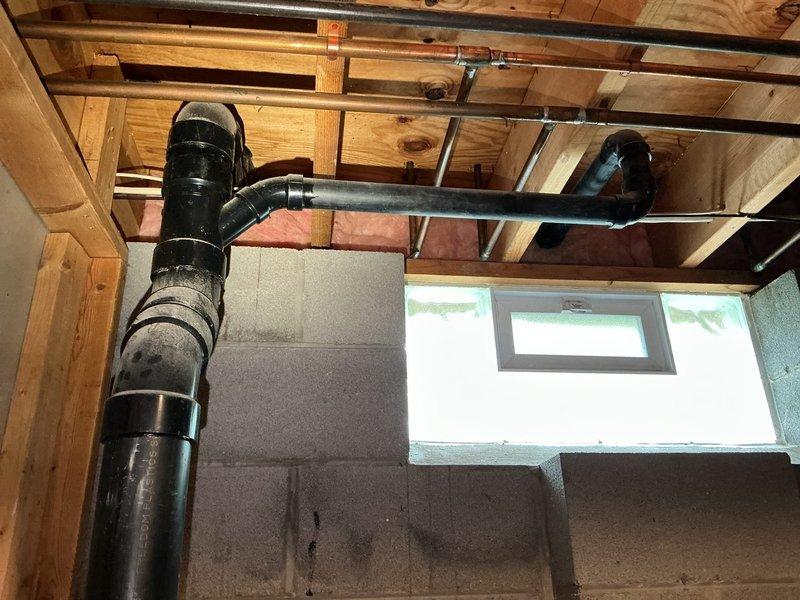Responded to multiple drain blockages affecting kitchen sink, dishwasher, garbage disposal, and bathroom sink. Upon arrival, found standing water in both basins of kitchen double-basin sink with cloudy, debris-laden water indicating complete drainage failure. Accessed main drain line through basement crawl space and cleared obstruction in primary waste stack. Restored proper drainage to all affected fixtures, verified garbage disposal operation, and confirmed dishwasher drain line was flowing freely.