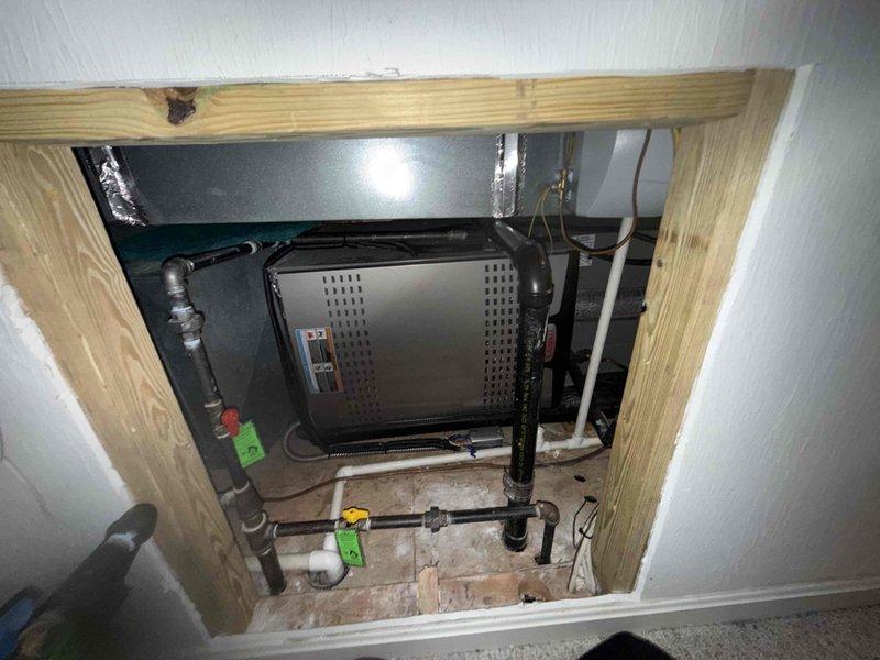 Completed scheduled MVP cooling maintenance visit. Accessed air handler unit through ceiling opening and inspected blower wheel assembly, noting dust accumulation on vertical blades and housing. Documented system components including ductwork, refrigerant lines, and associated plumbing infrastructure for maintenance records.