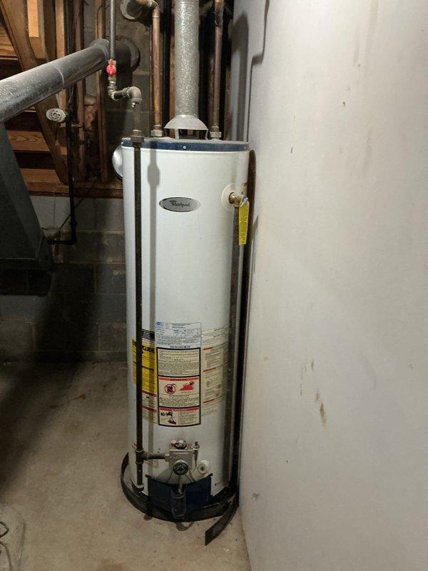 Completed standard maintenance flush and fill service on Whirlpool tanked water heater located in basement utility area. Drained sediment buildup from tank, flushed system thoroughly, and refilled unit to restore optimal heating efficiency and extend equipment lifespan. All plumbing connections, valves, and gas assembly components inspected and confirmed in proper working condition upon completion.