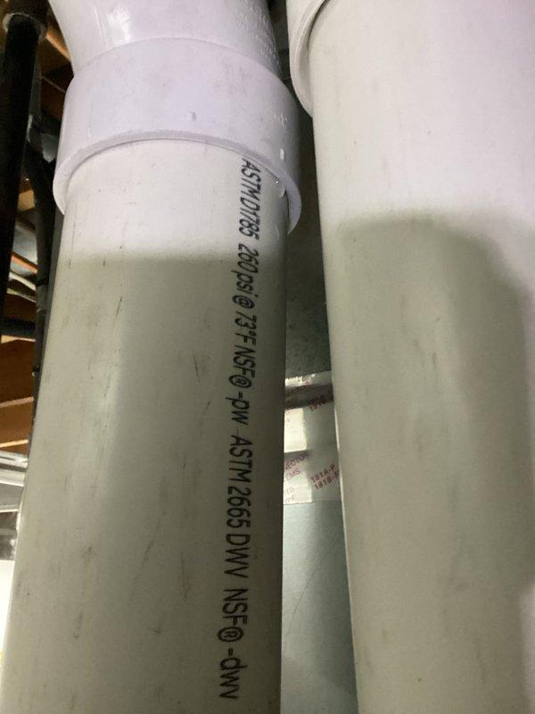 Completed routine MVP cooling maintenance visit. Inspected humidifier filter pad within housing unit, noting mineral deposit accumulation and discoloration on evaporator panel surface. Documented PVC condensate drain line configuration and verified proper installation standards compliance.
