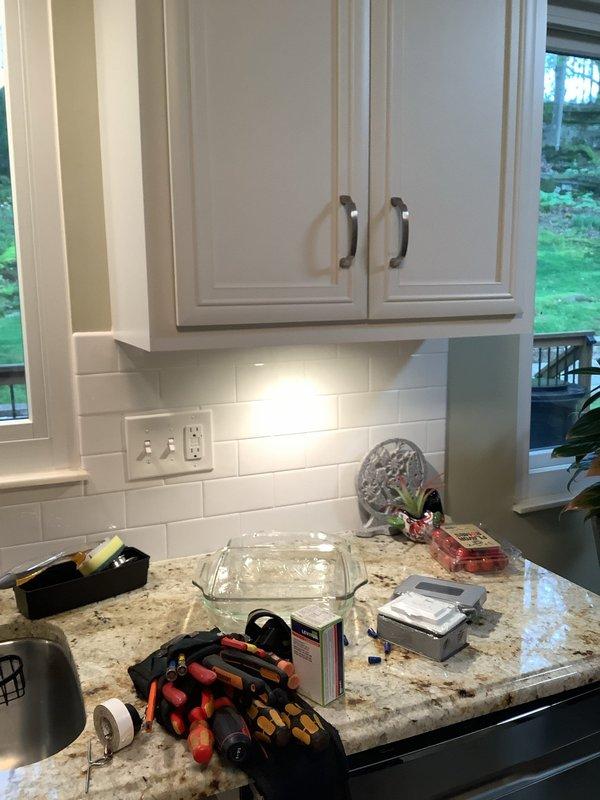 Repulled wiring for under cabinet lighting circuit on kitchen's far left section. Removed existing puck lights and installed three new 24-volt LED puck lights with corresponding 24-volt driver to ensure proper voltage compatibility and operation. 

Replaced exterior deck outlet with new GFCI receptacle and weatherproof cover. Attempted to source power from bathroom circuit to provide independent GFCI protection for deck outlet; however, existing bathroom GFCI already protects two additional bathrooms, making independent operation unfeasible without compromising current protection scheme. Completed installation with existing circuit configuration to maintain proper GFCI protection throughout affected areas.
