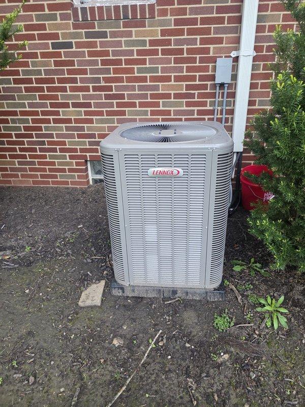 Completed annual air conditioning maintenance on 1-year-old Lennox cooling system. Performed comprehensive system inspection including outdoor condenser unit evaluation, refrigerant level verification, electrical connection testing, and component cleaning. Accessed upper level crawl space to inspect and service air filters, examined ductwork system throughout attic space including black flexible duct runs for proper airflow and connections. Provided thermostat operation instruction to restore system functionality. All components found operating within normal parameters with no deficiencies noted.