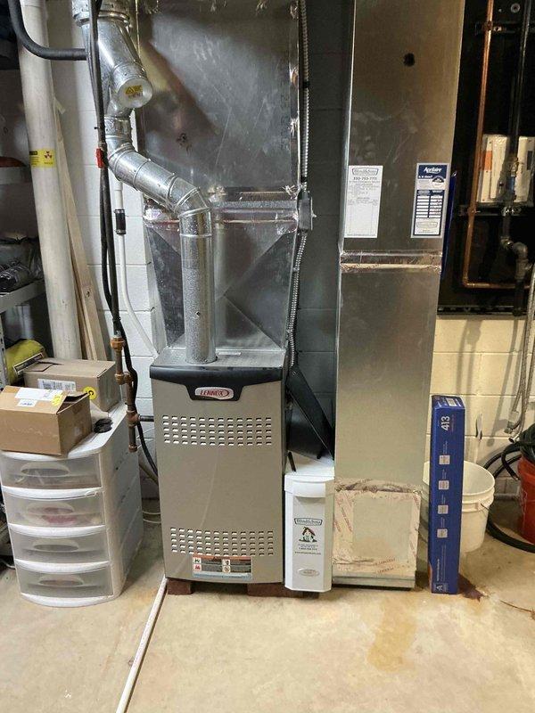 Completed HVAC estimate for air conditioning replacement due to identified leak in existing system. Evaluated residential basement installation featuring Lennox furnace with associated ductwork, exhaust piping, and auxiliary components. Documented current equipment configuration including gray metal cabinet furnace unit, metallic ductwork network with Y-junction connections, PVC drainage piping, and flexible tubing. Assessed system layout and mechanical room conditions to provide replacement recommendations and confirm ductwork compatibility for new equipment installation.