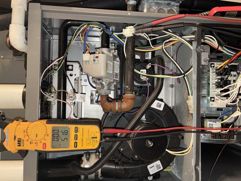Completed comprehensive heating maintenance visit on natural gas furnace system. Performed diagnostic testing of gas valve assembly with multimeter, confirming proper voltage reading of 57.5V during operational check. Inspected all internal mechanical and electrical components including inducer motor assembly, wiring harnesses, copper gas supply lines, and PVC venting system. All components found to be in normal working condition with proper connections and no visible signs of wear or damage. Verified airflow through ductwork and return air grille, confirming adequate system performance for continued reliable heating operation.