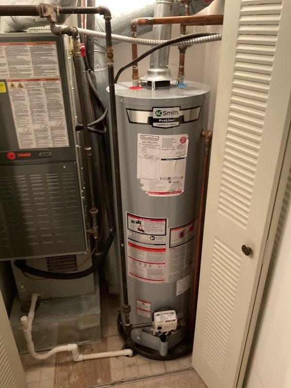Responded to service call for tanked water heater producing rumbling noises. Upon inspection, identified an AO Smith residential water heater exhibiting symptoms consistent with sediment accumulation at the tank bottom. Performed complete tank flush procedure by connecting garden hose to drain valve, draining contents until water ran clear, and removing mineral deposits and sediment buildup that had caused the reported rumbling sounds. Inspected all visible plumbing connections, copper supply lines, and pressure relief valve for proper operation and signs of corrosion or leakage. Verified temperature and pressure settings were within manufacturer specifications and confirmed unit returned to normal, quiet operation following the flush procedure.