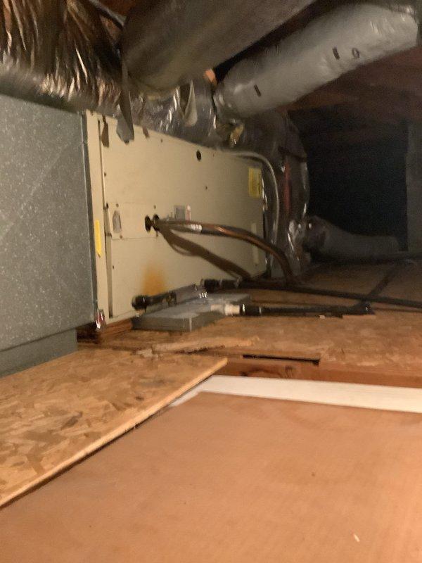 Completed full HVAC system installation in attic space, including new air handler unit with associated refrigerant lines, ductwork, and condensate drainage system. Installed flexible and rigid insulated ductwork, copper refrigerant piping, and PVC condensate drain with proper trap configuration. All components mounted on plywood platform with system tested and operational.