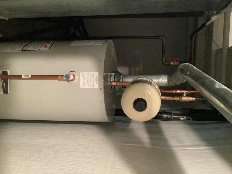 Replaced existing 40-gallon short atmospheric vent natural gas water heater in basement. Installed new ball valve, gas cock, and expansion tank to bring system up to current code requirements. Existing flue pipe was inspected and determined to be in good condition, requiring no replacement. All copper supply lines were reconnected with proper compression fittings, and the unit was tested for proper operation and safety compliance.