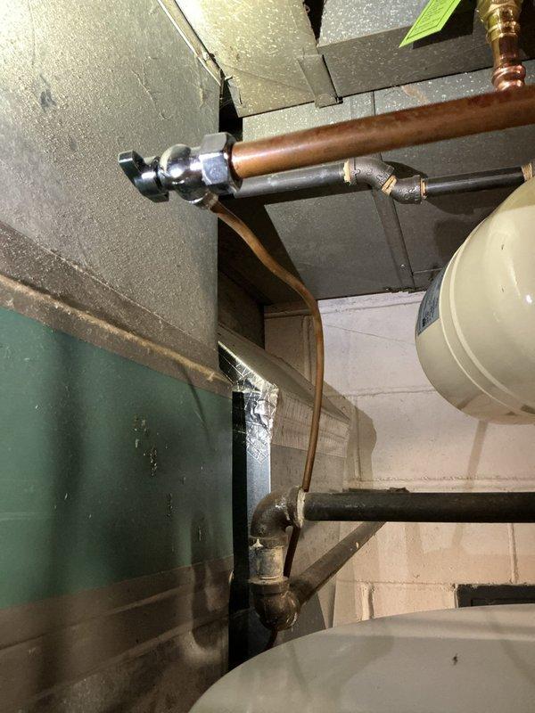 Responded to callback for water leak at humidifier valve following recent hot water tank installation. Upon inspection, identified active leak at humidifier saddle valve connection point on copper water line. Removed defective saddle valve fitting and replaced with new valve assembly. Tested all connections for proper seal and verified no further leakage present. System restored to full operation.