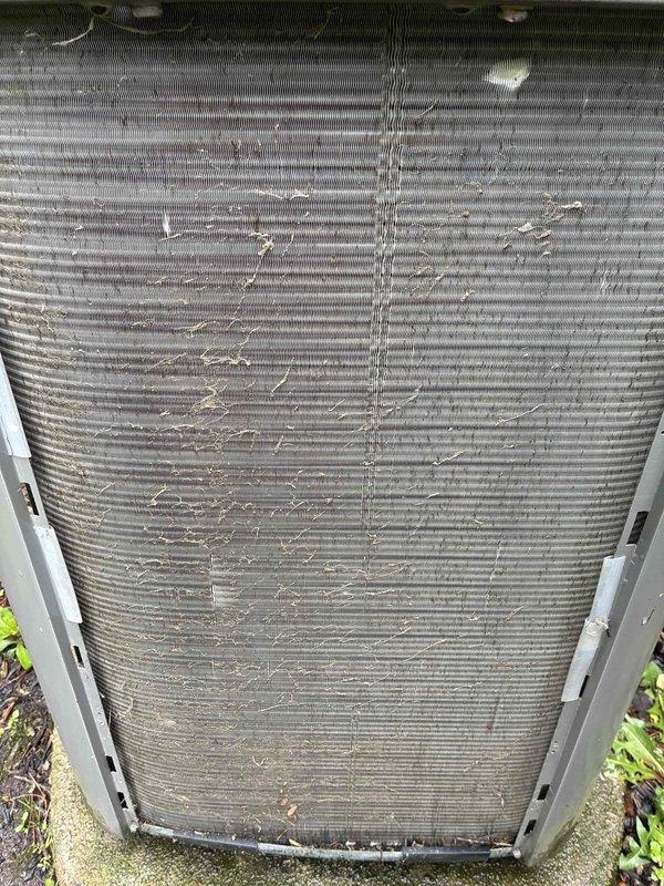 # HVAC Maintenance - Cooling

Performed comprehensive preventive maintenance on a 9-year-old residential air conditioning system under the maintenance value plan. Upon arrival, conducted visual inspection of the outdoor condenser unit, which revealed moderate accumulation of debris and dust particles on the condenser coil fins. The unit was operating but showed signs of reduced airflow efficiency due to the buildup on the coil surfaces.

Completed standard maintenance procedures including cleaning of the condenser coils to remove accumulated dirt, dust, and organic debris from the fin surfaces. Inspected the condenser fan motor and verified proper operation. Checked electrical connections and confirmed secure mounting on the concrete pad. Evaluated the overall condition of the unit's exterior housing and protective mesh panels, noting typical weathering consistent with outdoor exposure.

Verified refrigerant levels and system pressures within manufacturer specifications. Tested system 