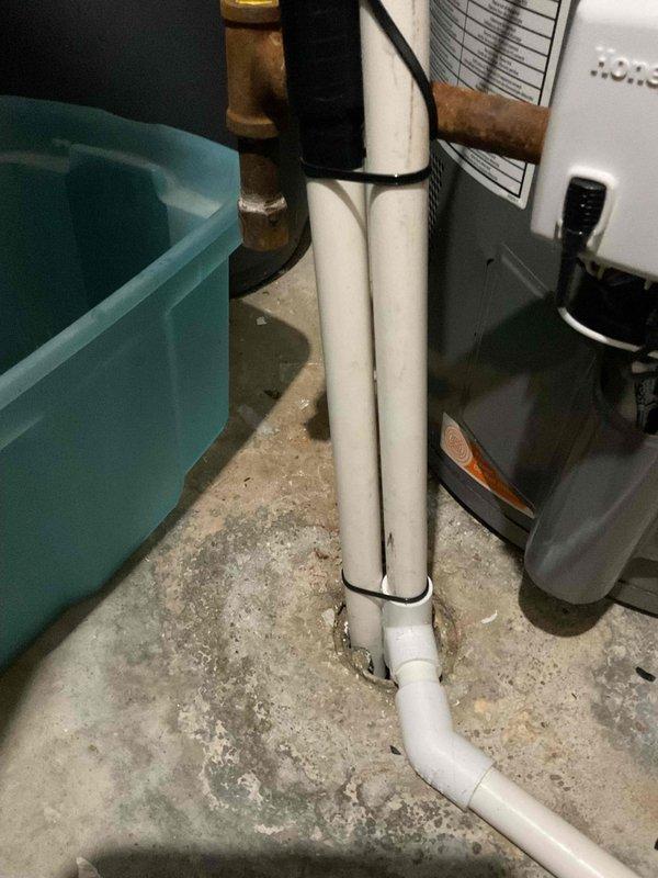 Responded to callback for reported water leak in utility area near recently installed furnace. Upon inspection, identified water staining on concrete floor around PVC condensate drain lines and condensate pump assembly. Customer claimed improper installation of furnace drainage system was causing recurring leak. Thorough examination revealed condensate drainage piping from furnace was properly installed with correct pitch and secure connections using appropriate zip-tie mounting. Leak source determined to be unrelated to furnace installation—traced to separate plumbing system with copper piping and brass fittings visible above the condensate lines. Documented conditions with photos showing water damage patterns on floor, properly installed white PVC condensate drain configuration, condensate pump operation, and nearby plumbing components. Advised customer that leak is not associated with furnace installation work and originates from different system requiring separate plumbing repair.