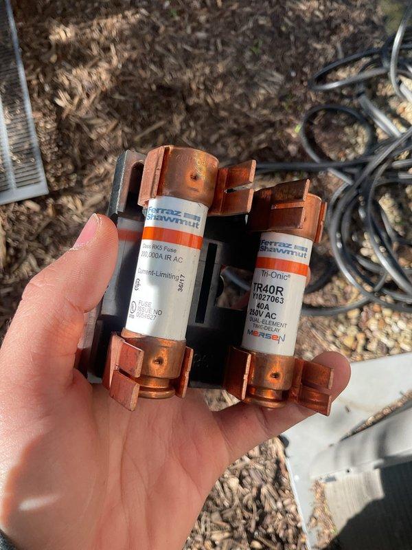Responded to no cooling call and performed diagnostic evaluation of outdoor condensing unit. Upon inspection, discovered failed fuses in disconnect box preventing power to compressor and condenser fan motor. Removed and replaced dual Ferraz Shawmut TR40R 600V AC time-delay fuses, restored power to unit, and verified proper system operation with all components running within normal parameters.