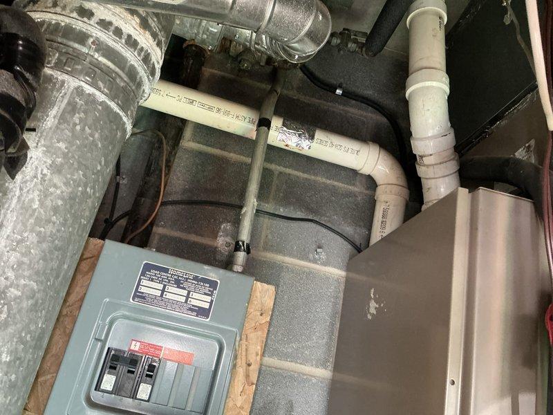 Completed HVAC system replacement estimate for 32-year-old furnace and air conditioning unit with identified refrigerant leak. Assessed existing National Comfort Products outdoor condensing unit, ductwork configuration, electrical panel capacity, and PVC condensate drain lines in utility area. Provided comprehensive replacement quote for complete system upgrade.
