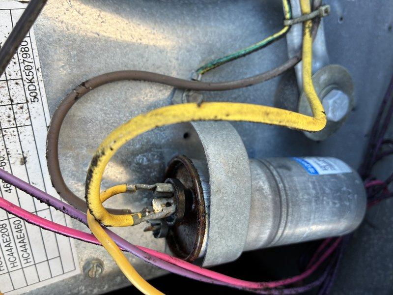 Performed maintenance and repair on dual rooftop unit system. Replaced air filters in both RTU units to restore proper airflow. Replaced failed run capacitor on front unit motor to restore compressor operation. Conducted chemical wash treatment on evaporator coil to remove significant accumulation of dirt, dust, and biological growth that was restricting airflow and reducing heat transfer efficiency. Coil exhibited heavy brownish-tan discoloration and white crusty deposits across fin surfaces prior to cleaning. All components tested and verified operational upon completion.