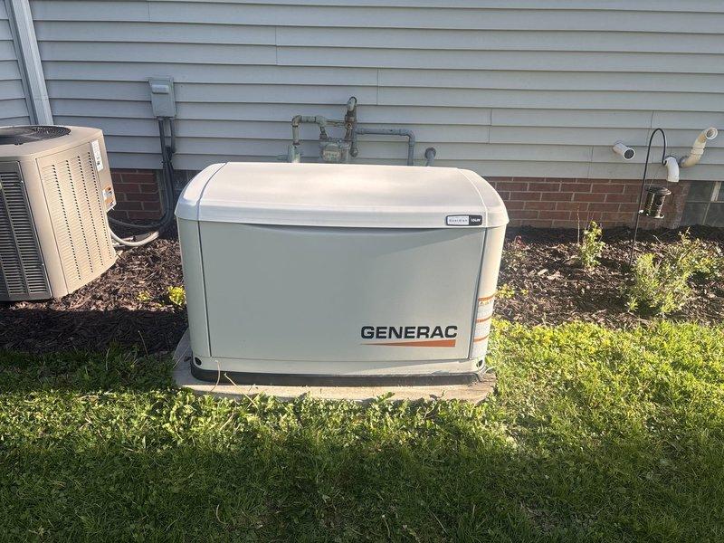 Completed scheduled preventive maintenance on residential Generac backup generator system. Performed comprehensive visual inspection of generator unit, verifying proper installation on concrete pad with secure mounting and adequate clearance. Inspected all external components including housing integrity, ventilation louvers, and weather sealing.

Conducted battery system diagnostics using electronic battery tester, confirming battery voltage at 14.07V with "GOOD" status. Verified battery terminals for proper connection, corrosion control, and secure mounting. Tested charging system functionality to ensure battery maintains proper charge during standby mode.

Inspected all utility connections including natural gas supply piping, electrical conduit runs, and transfer switch wiring. Verified proper routing and mounting of all pipes and conduits along building exterior with appropriate support and weatherproofing. Confirmed no visible leaks, damage, or deterioration to gas lines or electri