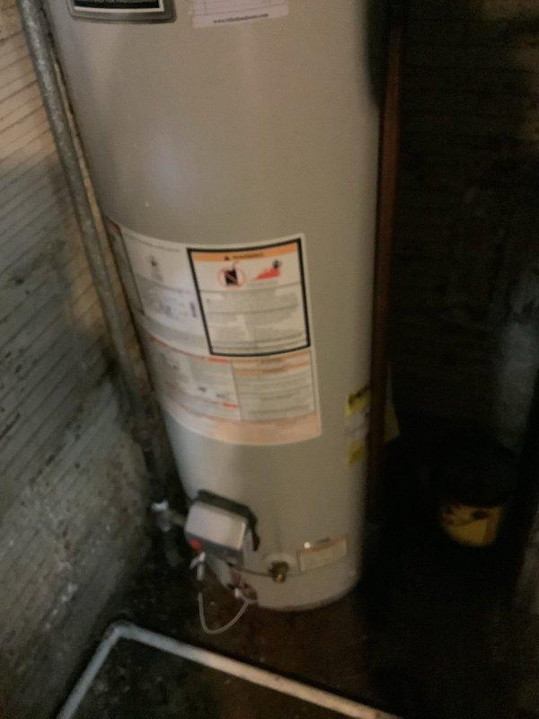 Responded to emergency water leak from hot water tank. Upon inspection, confirmed active leak at base of unit requiring immediate attention. Documented existing water heater condition and surrounding plumbing connections for service records.