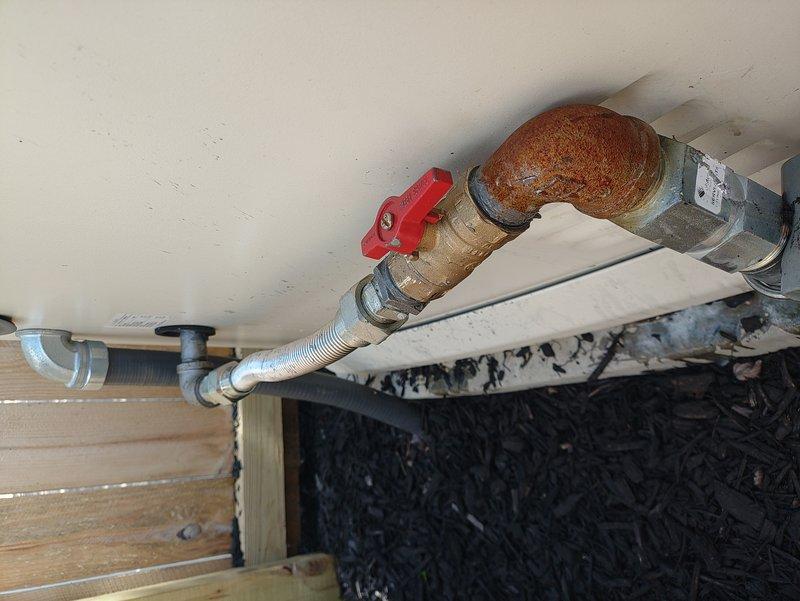 Responded to gas odor complaint near generator location. Performed comprehensive visual inspection of gas piping system and connections. Inspection revealed severely corroded 90-degree elbow fitting and compromised pipe sections with heavy rust deterioration on gas line components. Conducted pressure test on gas system to verify leak location and system integrity. Identified corroded fittings as primary concern requiring immediate replacement due to structural compromise and safety hazard. Documented conditions with photographs showing extensive corrosion on metal pipe sections, valve connections, and elbow fittings. Recommended complete replacement of corroded gas line components including elbow fitting, associated piping sections, and hardware to ensure safe operation and eliminate gas leak potential.