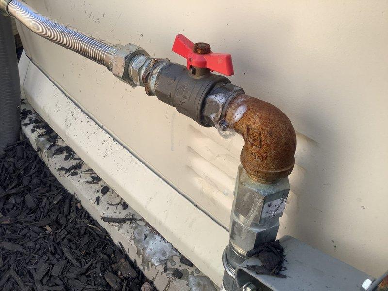 Responded to gas odor complaint near generator location. Performed comprehensive visual inspection of gas piping system and connections. Inspection revealed severely corroded 90-degree elbow fitting and compromised pipe sections with heavy rust deterioration on gas line components. Conducted pressure test on gas system to verify leak location and system integrity. Identified corroded fittings as primary concern requiring immediate replacement due to structural compromise and safety hazard. Documented conditions with photographs showing extensive corrosion on metal pipe sections, valve connections, and elbow fittings. Recommended complete replacement of corroded gas line components including elbow fitting, associated piping sections, and hardware to ensure safe operation and eliminate gas leak potential.