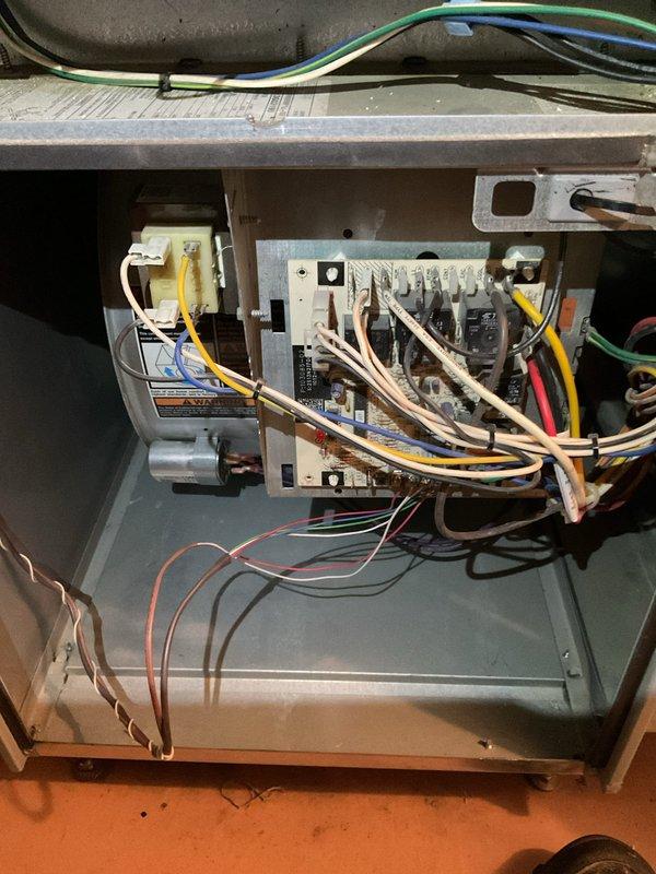 Responded to no-heat call on 13-year-old furnace that would not stay running and was blowing cold air when operational. Performed diagnostic testing using multimeter to check electrical components and control board functionality. Upon inspection, identified issues with the furnace's heating cycle and electrical system. Tested voltage readings at the control board, which displayed 255V on the diagnostic meter. Removed access panel to access internal components, examined control board, transformer, wiring connections, and safety circuits. All findings documented with photos for service records.