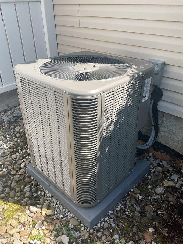 Performed routine HVAC maintenance on residential cooling system. Inspected outdoor condensing unit, verified proper installation on pad with adequate clearance, checked refrigerant line connections and electrical disconnect. Measured and recorded system parameters including temperature readings of 66.1°F to assess operational performance and ensure unit is functioning within manufacturer specifications.