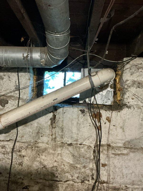 Completed comprehensive evaluation of 15-year-old Goodman gas furnace and air conditioning system for replacement with heat pump HVAC system in single-family residence built in the 1880s. Assessed existing ductwork condition in basement area, noting aged galvanized metal ducts with visible wear and deterioration, and evaluated requirements for partial or full ductwork replacement to accommodate new heat pump installation. Documented existing infrastructure including exposed masonry foundation walls showing age-related deterioration, moisture staining, and multiple utility penetrations; coordinated assessment with planned electrical service upgrade to ensure proper capacity for new heat pump system.