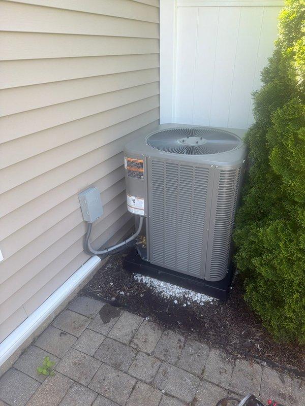 Completed installation of downflow air conditioning system at residential property. Installed outdoor condensing unit on paver patio with proper electrical disconnect and conduit routing, positioned unit against exterior wall with adequate clearance for airflow and maintenance access. Replaced damaged fuse block assembly that showed signs of heat exposure, installed new dual-fuse protection with proper amperage rating to ensure safe electrical operation of the system.