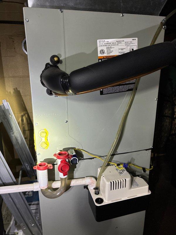 Completed routine preventive maintenance cooling visit on 9-year-old residential HVAC system. Performed comprehensive inspection of air handler unit located in attic space, including examination of all major components, electrical connections, and refrigerant lines. Verified proper operation of condensate drainage system with PVC trap configuration and condensate pump assembly. Inspected evaporator coil assembly, refrigerant line connections, and associated brass fittings for proper operation and potential leaks. All components found operating within normal parameters with no immediate service needs identified.