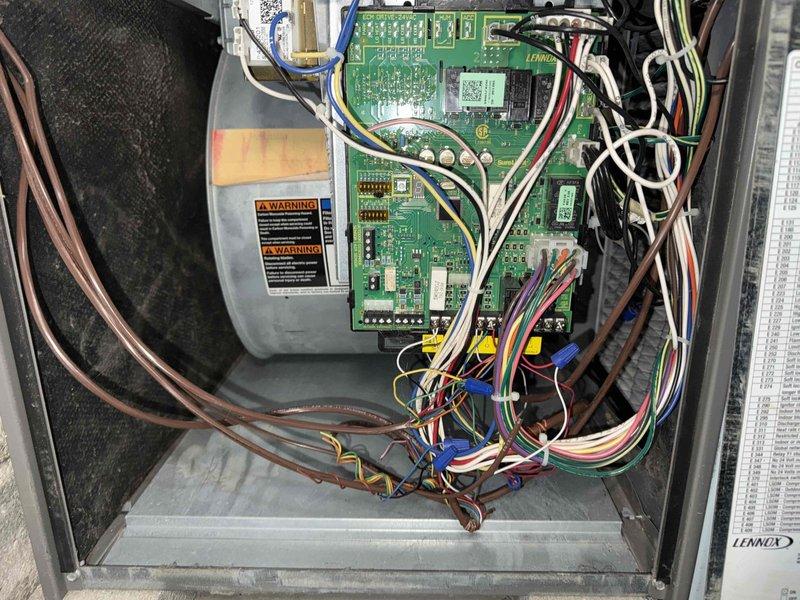 Completed preventative maintenance cooling visit on 6-year-old Lennox air conditioning system. Performed comprehensive inspection of air handler and furnace assembly located in basement utility area. Verified proper operation of electronic control board and blower motor components. Inspected PVC condensate drain lines and confirmed proper drainage configuration with no blockages present. Checked electrical connections, wiring harnesses, and digital display panel functionality. Examined ductwork insulation and verified secure metallic tape sealing. System operating within normal parameters with all safety controls functioning properly.