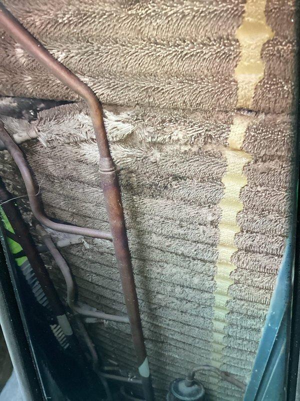 Completed comprehensive preventive maintenance on 11-year-old air conditioning system. Inspected evaporator coil and found moderate dust accumulation and discoloration on fin surfaces, with visible contamination affecting heat transfer efficiency. Evaluated air filtration system and noted pleated filter with dust buildup requiring attention. Performed standard maintenance protocol including system inspection, component evaluation, and documentation of equipment condition to ensure continued operational performance.
