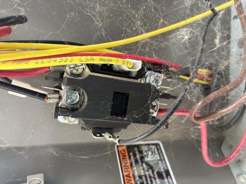 Completed cooling maintenance visit on HVAC system. Inspected electrical components including terminal block connections and relay switch assembly. Found excessive dust, debris, and cobweb accumulation on electrical components and surrounding surfaces, which can impede proper system operation and create potential safety concerns. Documented equipment condition with photos showing four-terminal connector block and relay component with multiple wire connections. System components including blower motor assembly were accessible for inspection in outdoor enclosure location.