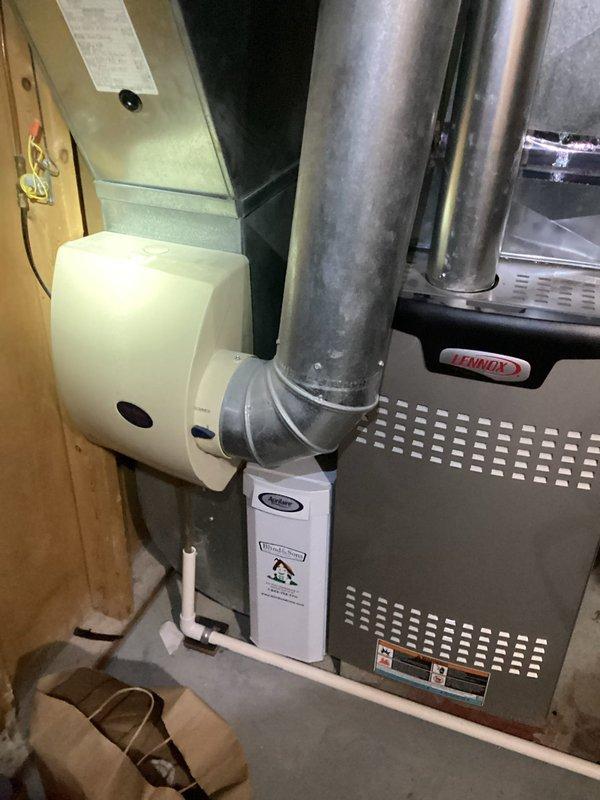 Completed MVP cooling maintenance visit on 5-year-old Lennox HVAC system. Inspected furnace unit, humidifier assembly, and associated ductwork; verified proper operation of humidifier pad and airflow components. All equipment found in satisfactory working condition with normal dust accumulation for routine service interval.