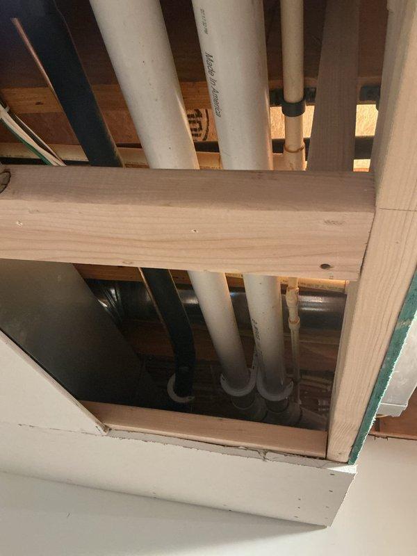 Conducted site assessment for installation of macerator/drain pump system for basement sink in single family residence with no existing waste pump infrastructure. Evaluated structural framing, existing plumbing lines, and electrical routing through floor joists to determine optimal installation location and connection points for new SaniFlo-type system. Documented existing PVC drain lines, copper water supply, and available access points through floor cavity for future pump discharge line integration.