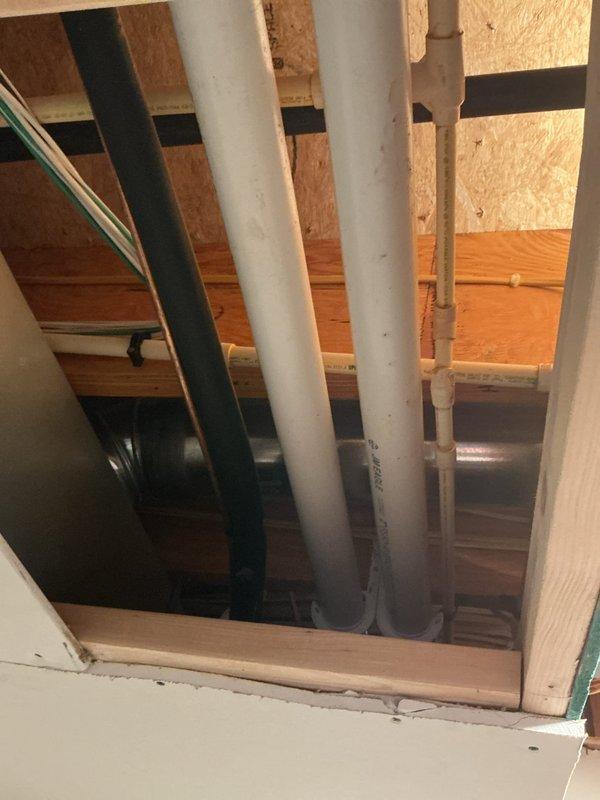 Conducted site assessment for installation of macerator/drain pump system for basement sink in single family residence with no existing waste pump infrastructure. Evaluated structural framing, existing plumbing lines, and electrical routing through floor joists to determine optimal installation location and connection points for new SaniFlo-type system. Documented existing PVC drain lines, copper water supply, and available access points through floor cavity for future pump discharge line integration.