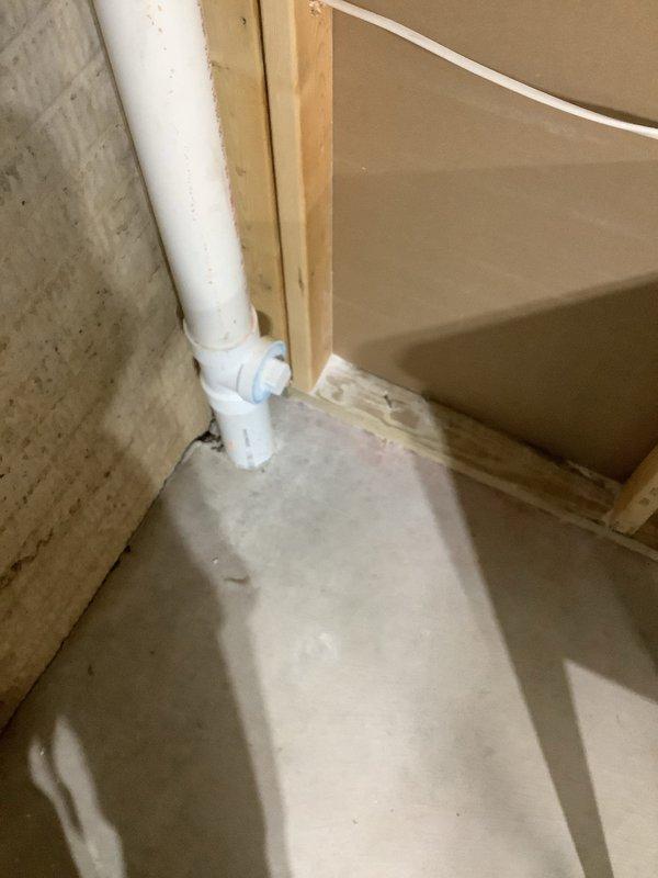 Provided quote for utility tub water and sewer hook-up installation in basement area. Assessed existing plumbing infrastructure, including vertical PVC drain line and connection points along concrete block wall. Evaluated rough-in requirements for proper drainage and water supply connections to accommodate new utility sink installation. Documented existing conditions with photos showing basement framing, concrete flooring, and current plumbing configuration to support accurate quote preparation.