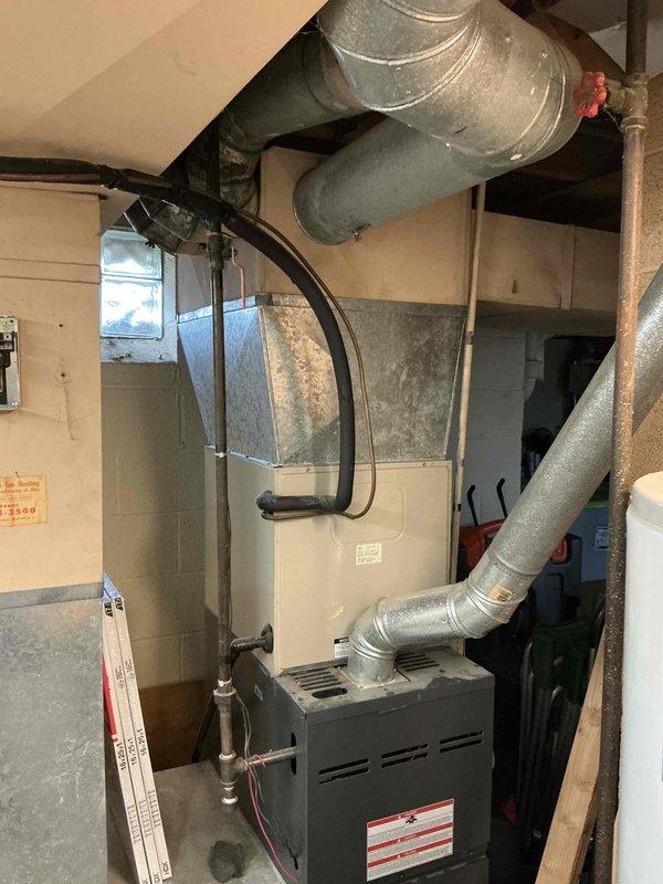 Conducted on-site evaluation for replacement of existing 20-year-old furnace and air conditioning system. Assessed current HVAC equipment condition, measured installation space, and documented existing ductwork configuration in basement utility area. Provided comprehensive replacement estimate for new heating and cooling system to address aging equipment concerns.