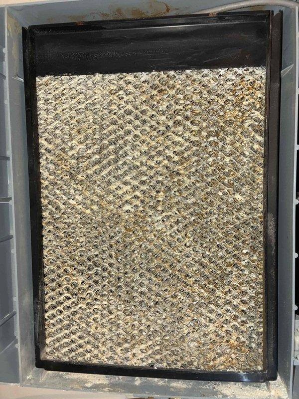 Performed cooling maintenance on residential HVAC system between 8:00 AM and 9:00 AM. Inspected outdoor condenser unit and replaced heavily soiled evaporator pad/filter media that had accumulated significant dust and debris, restricting proper airflow. Noted vegetation encroachment near unit intake requiring clearance for optimal system performance.