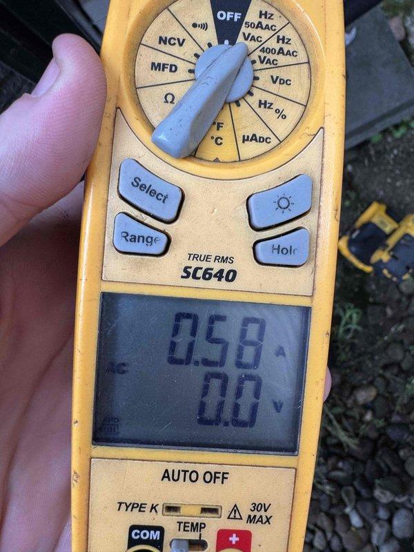 Performed routine air conditioning maintenance on a 12-year-old system. Conducted electrical diagnostics using clamp meter to verify amp draw of 0.58A and measured capacitor at 4859 microfarads to ensure proper compressor operation. All measurements within normal operating parameters; system operating efficiently with no deficiencies noted.